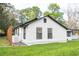Side view of a charming white farmhouse with black trim and metal roof at 2751 Ne 46Th St, Ocala, FL 34479