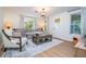 Living room with gray sectional sofa, coffee table, and two armchairs at 2751 Ne 46Th St, Ocala, FL 34479