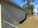 House side view with chain link fence at 40 Bahia Pass, Ocala, FL 34472