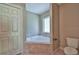 Bathroom with corner bathtub, toilet and double door closet at 5230 Nw 56Th Ter, Ocala, FL 34482