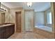 Bathroom with corner bathtub, toilet and double door closet at 5230 Nw 56Th Ter, Ocala, FL 34482