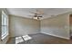 Bright bedroom featuring a large window and ceiling fan at 5230 Nw 56Th Ter, Ocala, FL 34482
