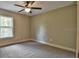 Spacious bedroom with carpeting and large window at 5230 Nw 56Th Ter, Ocala, FL 34482