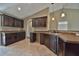 L-shaped kitchen with an island and dark wood cabinetry at 5230 Nw 56Th Ter, Ocala, FL 34482