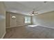 Bright and airy living room with neutral carpeting and ceiling fan at 5230 Nw 56Th Ter, Ocala, FL 34482