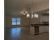 Bright living room features tile floors and a modern chandelier at 5489 Nw 12Th. St, Ocala, FL 34482