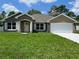 New construction home with a two-car garage and a well-manicured lawn at 5934 Nw 58Th Ter, Ocala, FL 34482