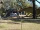 Backyard with a covered patio and a chain link fence at 611 Sw Shorewood Dr, Dunnellon, FL 34431