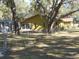 Home's back, featuring a screened enclosure and a chain link fence at 611 Sw Shorewood Dr, Dunnellon, FL 34431