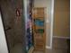 Bathroom with shower, linen closet, and colorful shower curtain at 611 Sw Shorewood Dr, Dunnellon, FL 34431