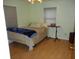 Bright bedroom featuring hardwood floors and a comfortable bed at 611 Sw Shorewood Dr, Dunnellon, FL 34431