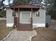 Mobile home exterior with covered entryway and stone path at 611 Sw Shorewood Dr, Dunnellon, FL 34431