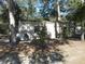 Tan colored detached garage in wooded area at 611 Sw Shorewood Dr, Dunnellon, FL 34431