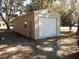 Detached garage with white door and side window at 611 Sw Shorewood Dr, Dunnellon, FL 34431