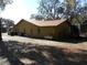 Side view of the house, showing a metal propane tank at 611 Sw Shorewood Dr, Dunnellon, FL 34431