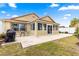 Large backyard patio with seating area and grill, perfect for outdoor entertaining at 637 Arteaga Way, The Villages, FL 32162