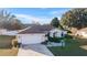 Single-story home with a driveway and a well-maintained lawn at 7854 Sw 62Nd Ct, Ocala, FL 34476