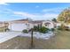 House exterior with a garage, garden, and walkway leading to the entrance at 7854 Sw 62Nd Ct, Ocala, FL 34476