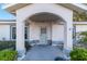 Inviting front porch with arched entryway and grey door at 7854 Sw 62Nd Ct, Ocala, FL 34476