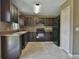Modern kitchen with dark wood cabinets, black appliances, and neutral countertops at 8585 Sw 139Th Lane Rd, Ocala, FL 34473