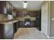 Modern kitchen featuring dark wood cabinets and black appliances at 8585 Sw 139Th Lane Rd, Ocala, FL 34473