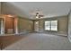Spacious living room with neutral carpeting and ceiling fan at 8585 Sw 139Th Lane Rd, Ocala, FL 34473