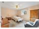 Cozy bedroom with ceiling fan and wood furniture at 9862 Se 179Th Pl, Summerfield, FL 34491