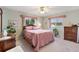 Relaxing bedroom with ceiling fan and soft bedding at 9862 Se 179Th Pl, Summerfield, FL 34491