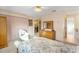 Spacious bedroom with dresser and view of dining area at 9862 Se 179Th Pl, Summerfield, FL 34491