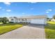 House with a white garage door and a brick paved driveway at 9862 Se 179Th Pl, Summerfield, FL 34491