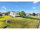 Side view of a single-story house with a palm tree and spacious yard at 9862 Se 179Th Pl, Summerfield, FL 34491