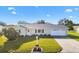 Front view of house with driveway and landscaping at 9862 Se 179Th Pl, Summerfield, FL 34491