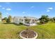 Exterior view of house with well-maintained lawn at 9862 Se 179Th Pl, Summerfield, FL 34491
