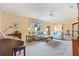 Spacious living room with light walls, neutral carpeting and comfy seating at 9862 Se 179Th Pl, Summerfield, FL 34491