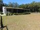 Single story home with screened porch and manicured landscaping at 11064 Ne 212Th Ln, Fort Mc Coy, FL 32134