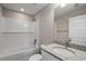 Bathroom with white subway tile, granite vanity, and bathtub at 13457 Sw 107Th Pl, Dunnellon, FL 34432