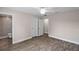 Bedroom with wood-look floors, ceiling fan, and access to bathroom at 13457 Sw 107Th Pl, Dunnellon, FL 34432