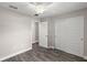 Bright bedroom with wood-look floors, ceiling fan, and double doors to closet at 13457 Sw 107Th Pl, Dunnellon, FL 34432