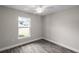 Bedroom with wood-look floors and a window overlooking backyard at 13457 Sw 107Th Pl, Dunnellon, FL 34432