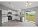 Modern kitchen with white shaker cabinets, granite countertops, and stainless steel appliances at 13457 Sw 107Th Pl, Dunnellon, FL 34432