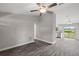 Open living room and kitchen with vinyl plank flooring and a sliding glass door at 13457 Sw 107Th Pl, Dunnellon, FL 34432