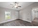 Living room with vinyl plank flooring, white door and a window at 13457 Sw 107Th Pl, Dunnellon, FL 34432