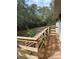 Wooden deck overlooks backyard with wooded area at 16510 Se 49Th Street Road, Ocklawaha, FL 32179