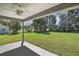 Covered patio overlooking a spacious backyard with lush lawn at 174 Pine Crse, Ocala, FL 34472