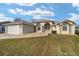 House exterior showcasing a two-car garage and well-maintained lawn at 2462 Nw 53 Ave Rd, Ocala, FL 34482