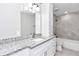 Modern bathroom featuring a white vanity, granite countertop, and gray tile at 2809 Ne 43Rd Rd, Ocala, FL 34470