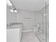 Clean bathroom featuring a double vanity, granite countertop and a glass shower at 2809 Ne 43Rd Rd, Ocala, FL 34470