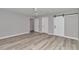 Primary bedroom with light grey walls, wood-look floors, and double barn doors at 2809 Ne 43Rd Rd, Ocala, FL 34470