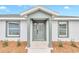 Front entrance with a stylish light gray door and sidelights at 2809 Ne 43Rd Rd, Ocala, FL 34470