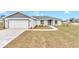 Newly constructed home with gray exterior, landscaping, and a two-car garage at 2809 Ne 43Rd Rd, Ocala, FL 34470